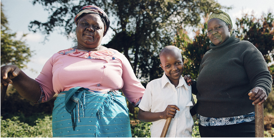 Two women and a child standing together outdoors